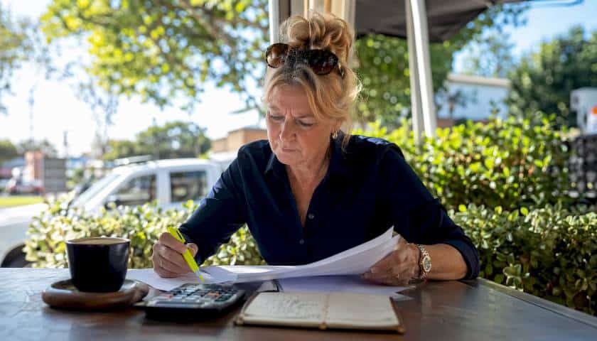 Woman reviewing horse float insurance documents