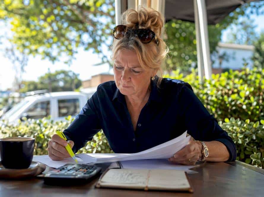 Woman reviewing horse float insurance documents