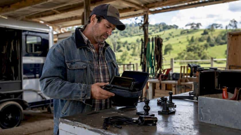 Man inspecting camera system in horse float workshop