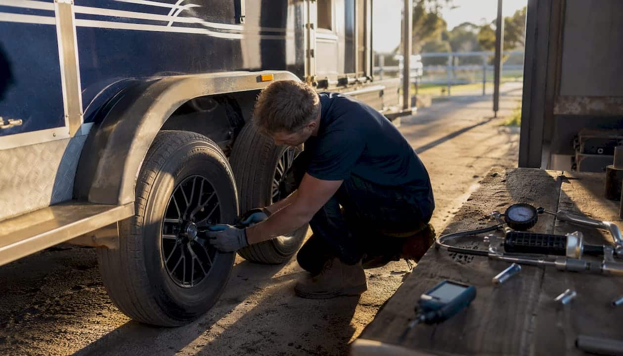 Hands installing tire pressure monitoring sensor